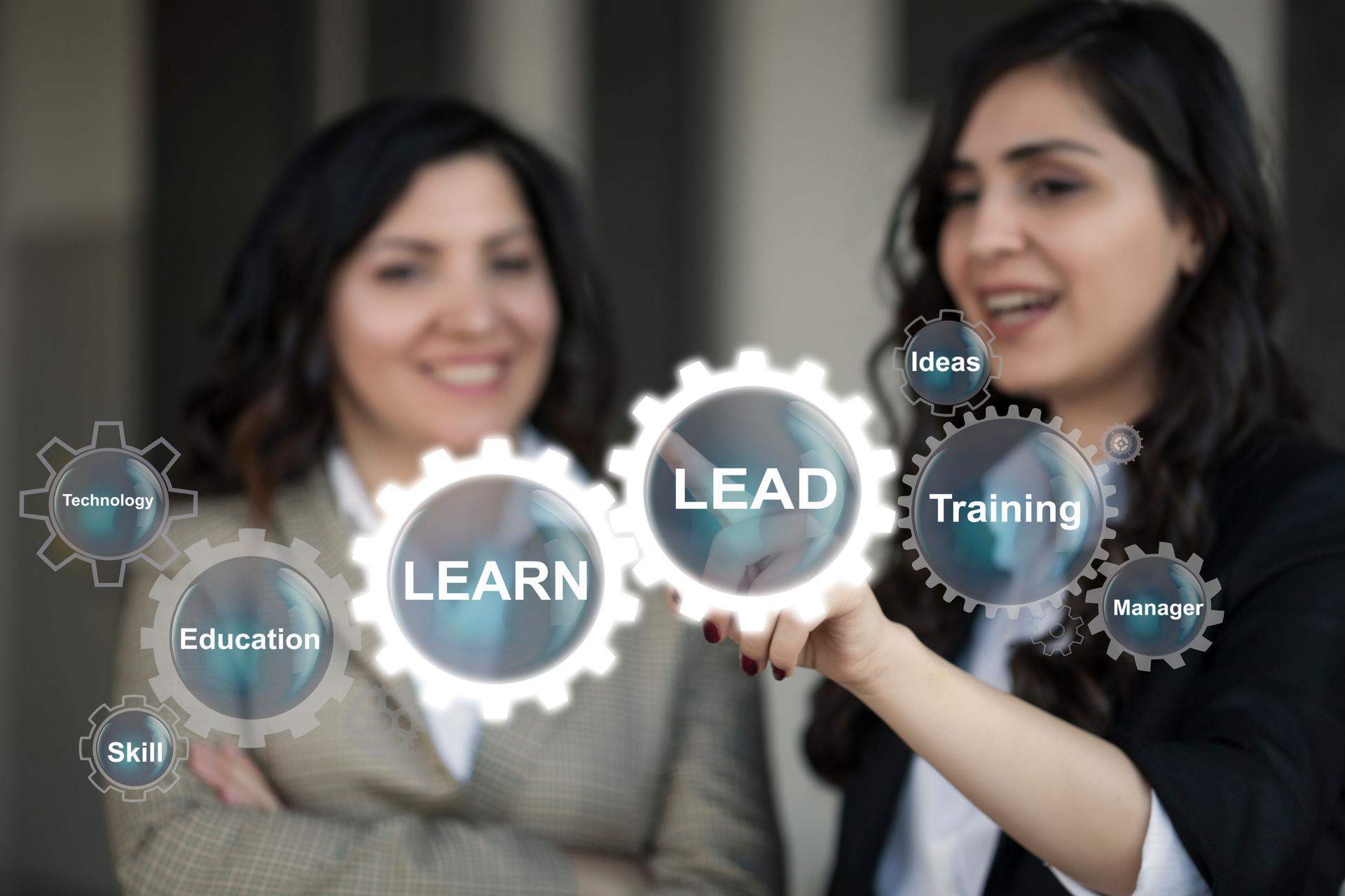 Learn and Lead concept two women learning sales and business concepts and techniques