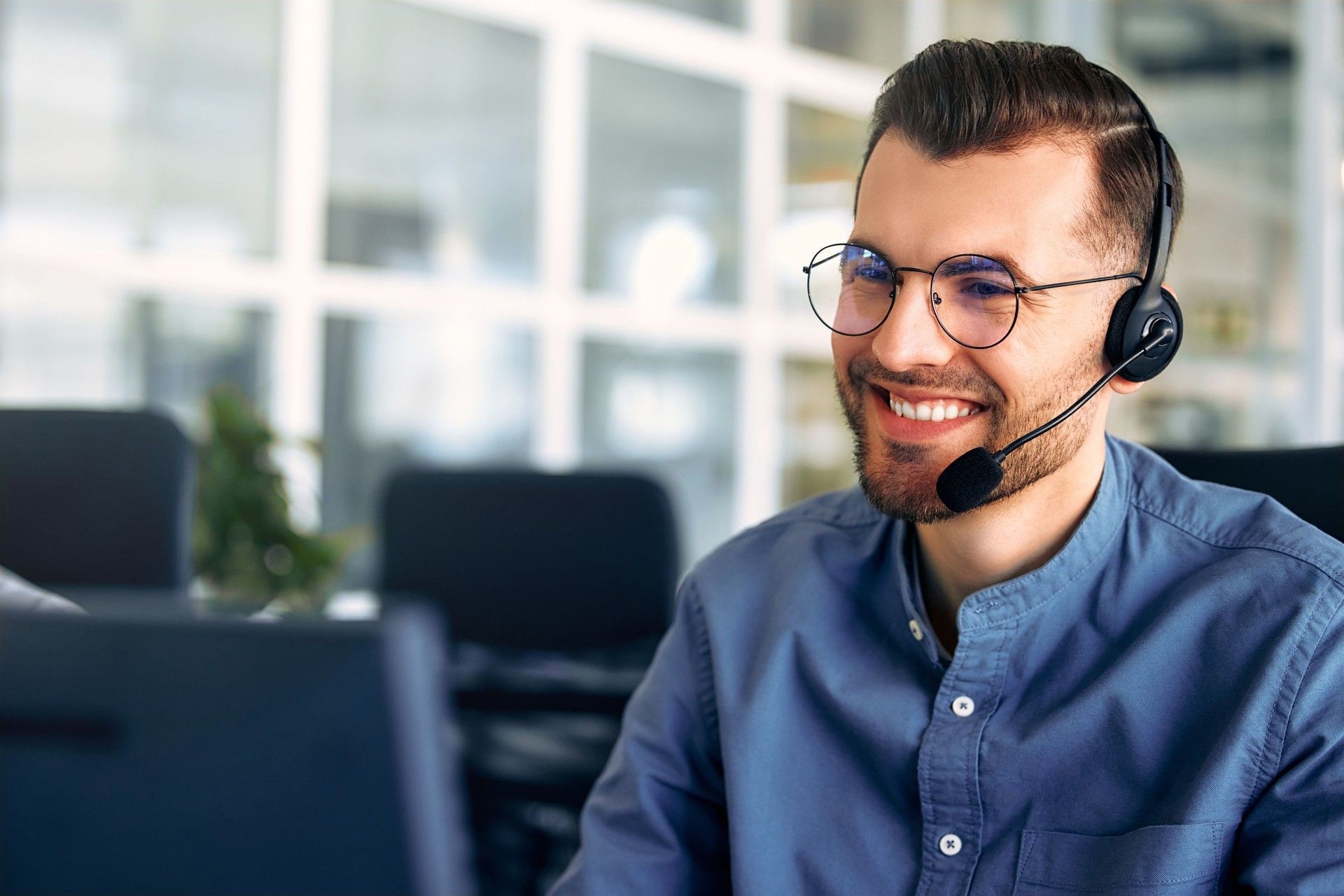 Man using phone skills in sales and business call center