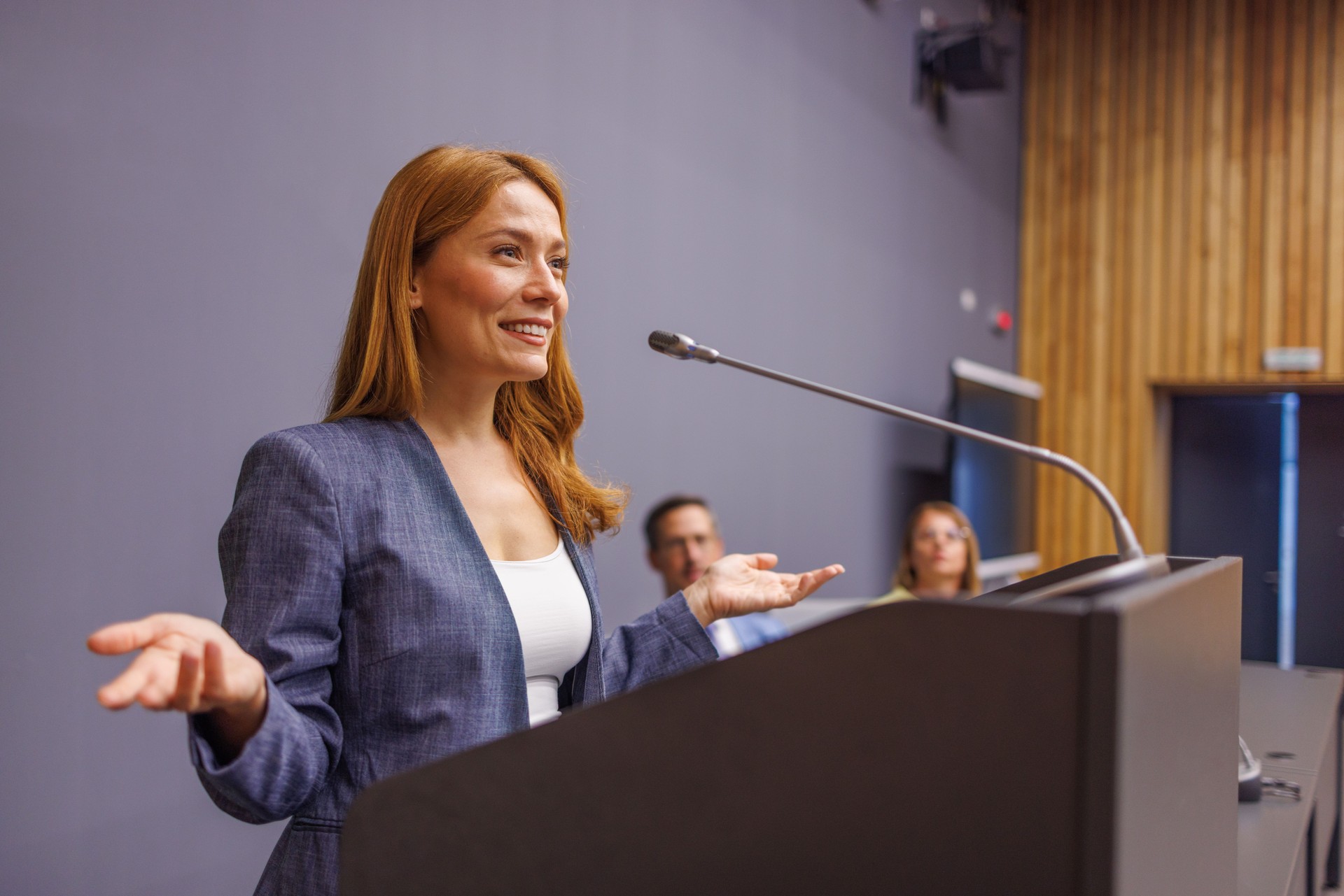 Motivational speaker inspiring audience with her presentation and communication skills.